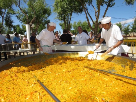 Reparto de la paella popular.