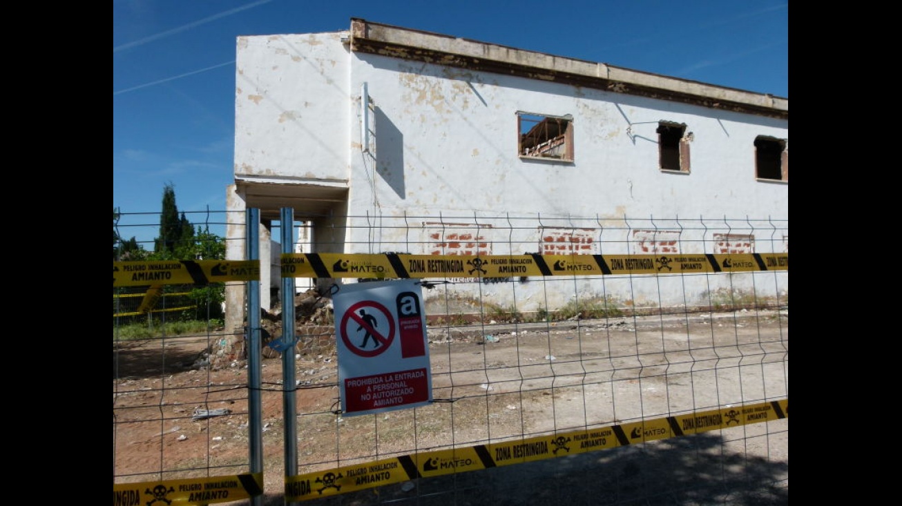 Durante los trabajos, el solar está vallado y advierte del peligro del amianto