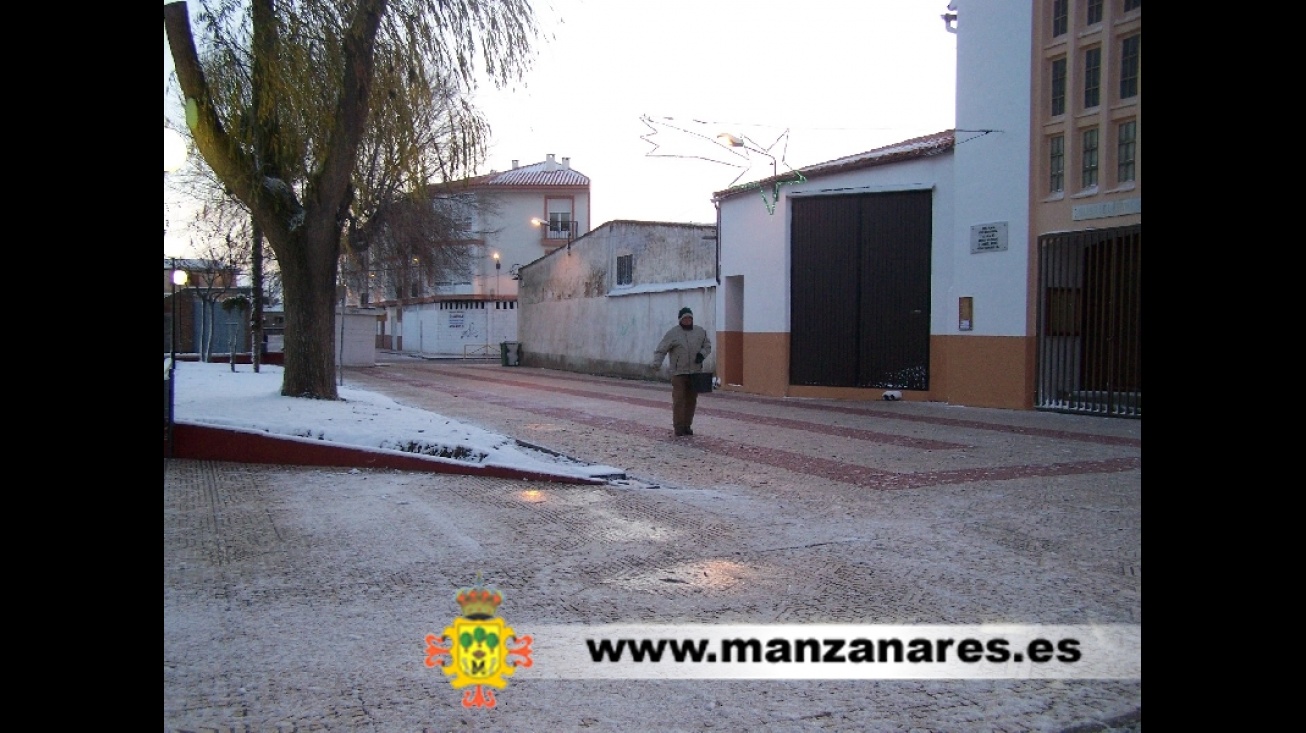 Operarios esparciendo sal en plaza Divina Pastora